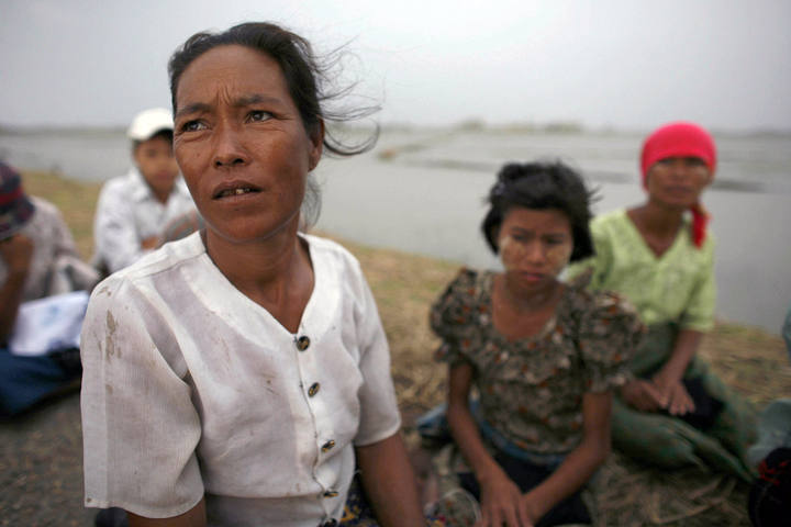 A woman waits for aid handouts near Danouk