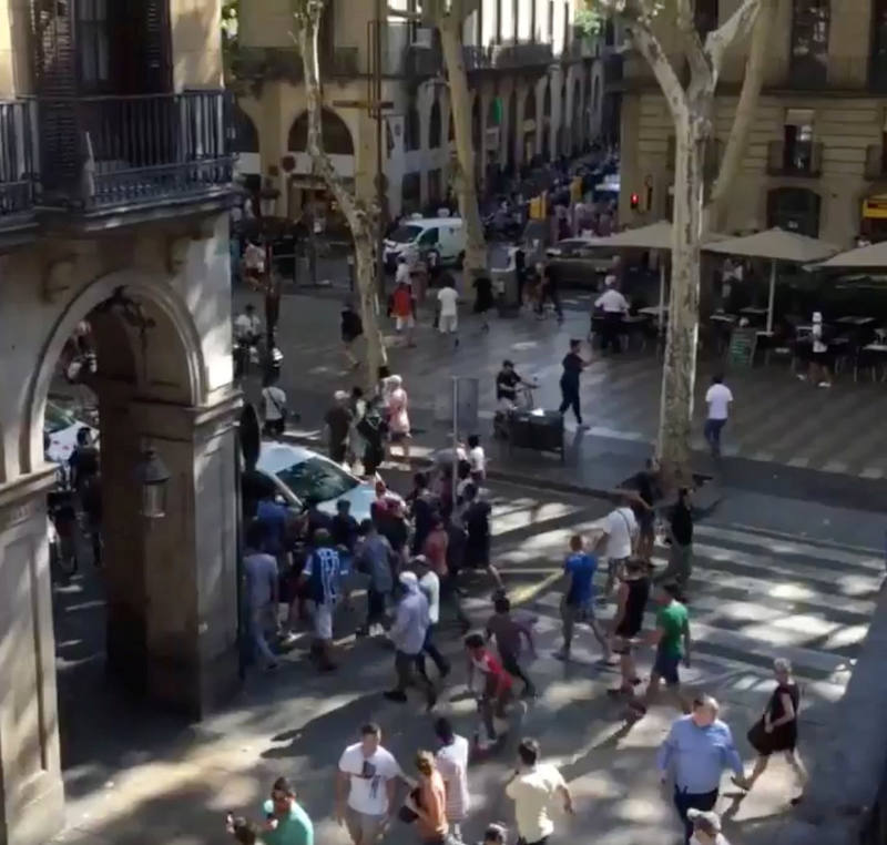 People move from the scene after a van crashed into pedestrians near the Las Ramblas avenue in central Barcelona
