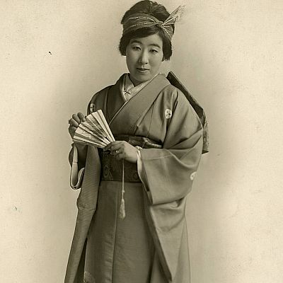 Retrato en blanco y negro de una soprano japonesa con kimono y abanico; expresión serena. Ilustración para un relato o programa titulado \"Sinfonía de la mañana\".