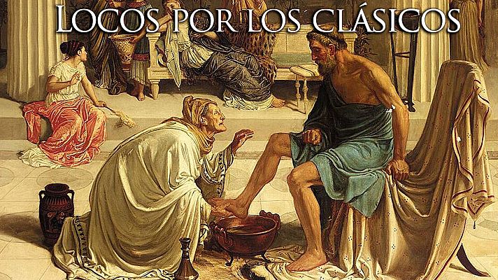 En un interior con arquitectura clásica, una mujer arrodillada lava los pies de un hombre sentado, revelando su identidad. Una segunda mujer observa la escena desde un lugar elevado, rodeada de otros personajes.