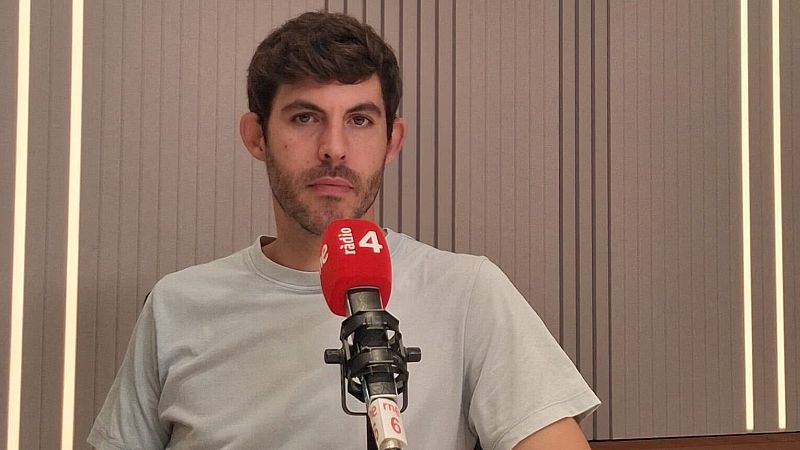 Carles Capella, con barba y bigote, mira al frente con expresi�n seria, delante de un micr�fono de "r�dio 4" con cubierta roja. Fondo de rayas marrones y grises.