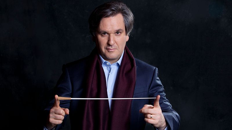Antonio Pappano, director de orquesta, en 2013. Traje oscuro, camisa azul, bufanda burdeos, anillo de boda y batuta blanca.