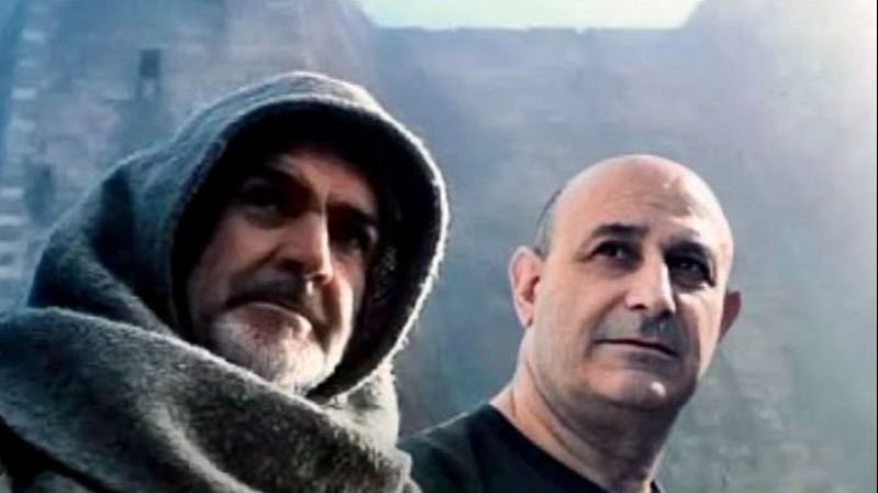Sean Connery como Guillermo de Baskerville y Jordi Hurtado, ambos con miradas reflexivas, en un fondo exterior borroso. Posible referencia a "El nombre de la rosa" y "S�n 4 dies".