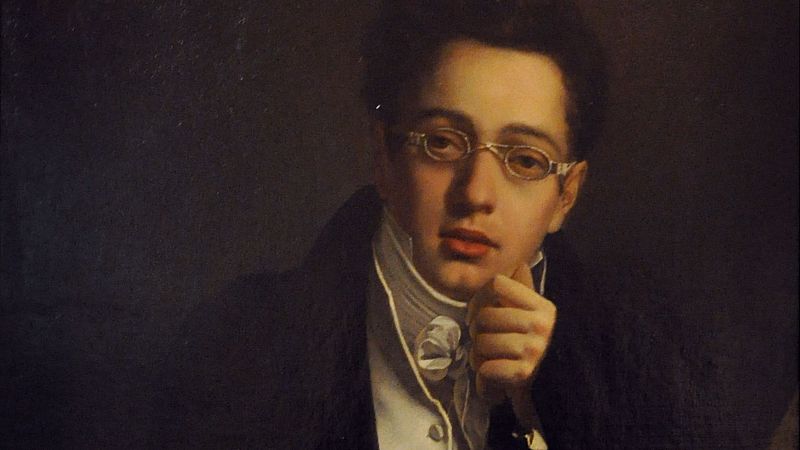 Pintura al �leo de un joven de tez p�lida con gafas finas, cabello rizado y expresi�n reflexiva, apoyando la mano bajo el ment�n sobre fondo oscuro.