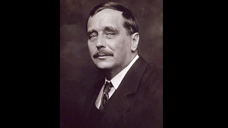 Retrato en tono sepia de H. G. Wells con elegante traje formal y bigote, mirando atentamente hacia la c�mara.