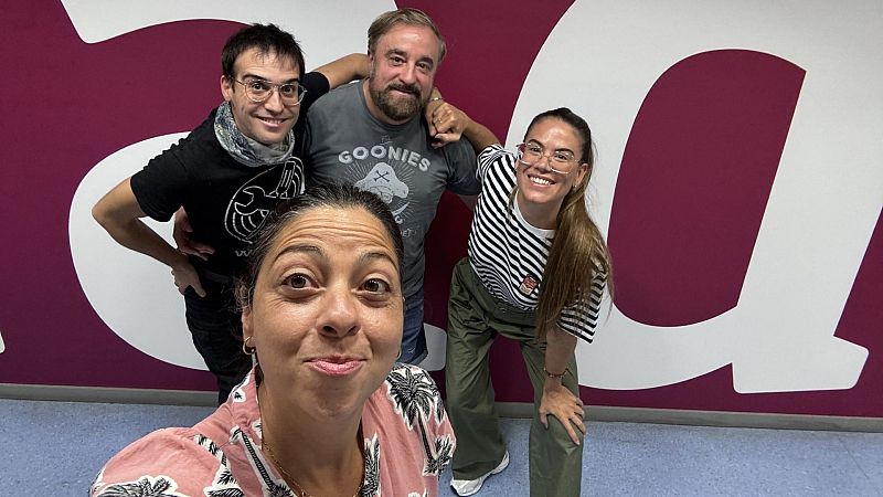 Selfi grupal de cuatro personas sonrientes en un estudio con pared magenta y logotipo blanco, destacando la presencia de Paloma Cortina sosteniendo la cámara junto a tres artistas.