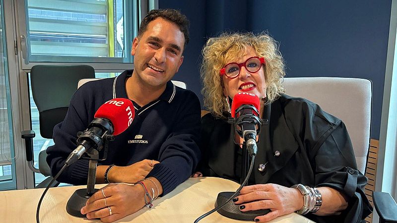 Dos personas sonrientes en un estudio de radio frente a micr�fonos con el logotipo de RNE, incluyendo al periodista Manel Ferrer y una mujer con gafas rojas.