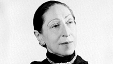 Retrato en blanco y negro de la escritora Magda Donato de tres cuartos, con cabello recogido, prenda oscura de cuello alto y collar de perlas.