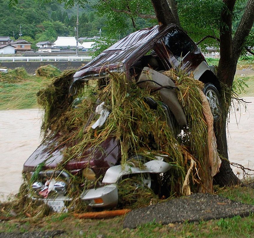 A car washed away by floodwaters is pictured in Sayo
