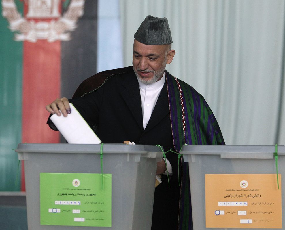 Afghan President Hamid Karzai casts his vote in the presidential election in Kabul