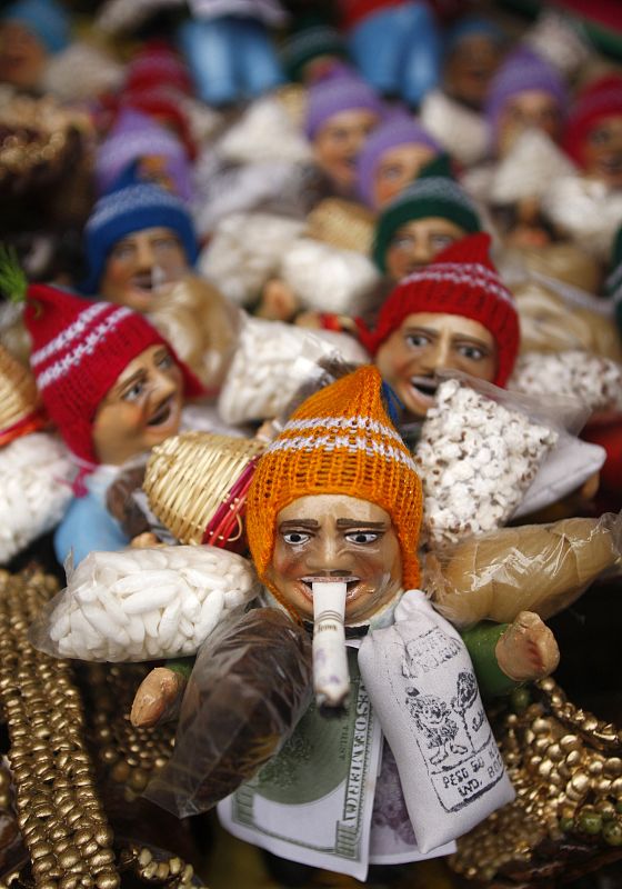 Dolls of Anden Ekekos, known as the god of abundance, are displayed in a market in Lima