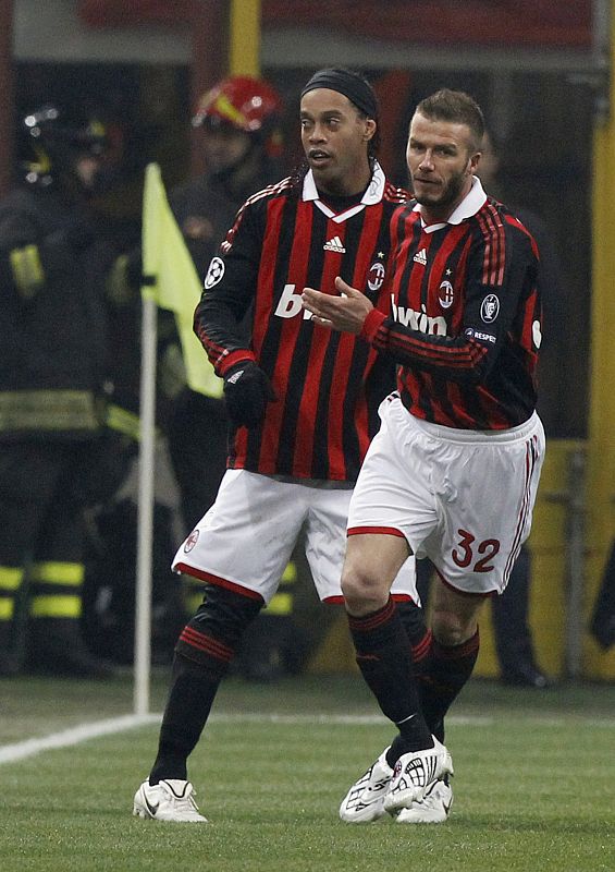 AC Milan's Beckham celebrates after teammate Ronaldinho scores against Manchester United during their Champions League soccer match in Milan