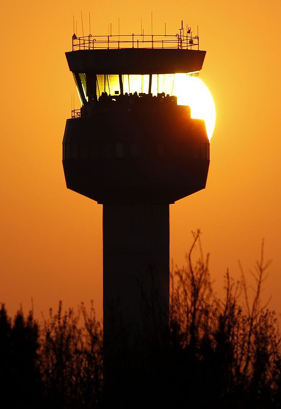 The sun sets behind the air traffic control tower at East Midlands Airport