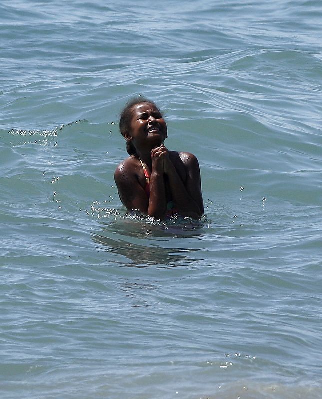 Sasha, daughter of U.S. first lady Michelle Obama, bathes in the Mediterranean Sea in Estepona during their vacation in southern Spain