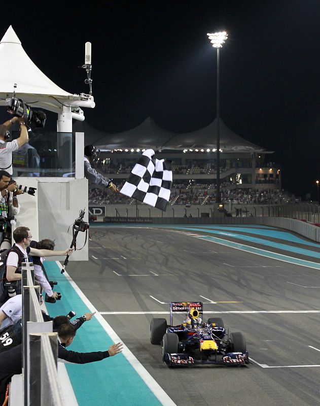Red Bull Formula One driver Sebastian Vettel of Germany crosses the finish line to win the Abu Dhabi F1 Grand Prix at Yas Marina circuit in Abu Dhabi