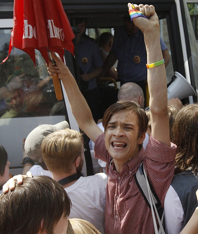 A gay rights activist shouts as he is pushed away from the scene of a Gay Pride event by the police to prevent clashes with anti-gay protesters in St. Petersburg