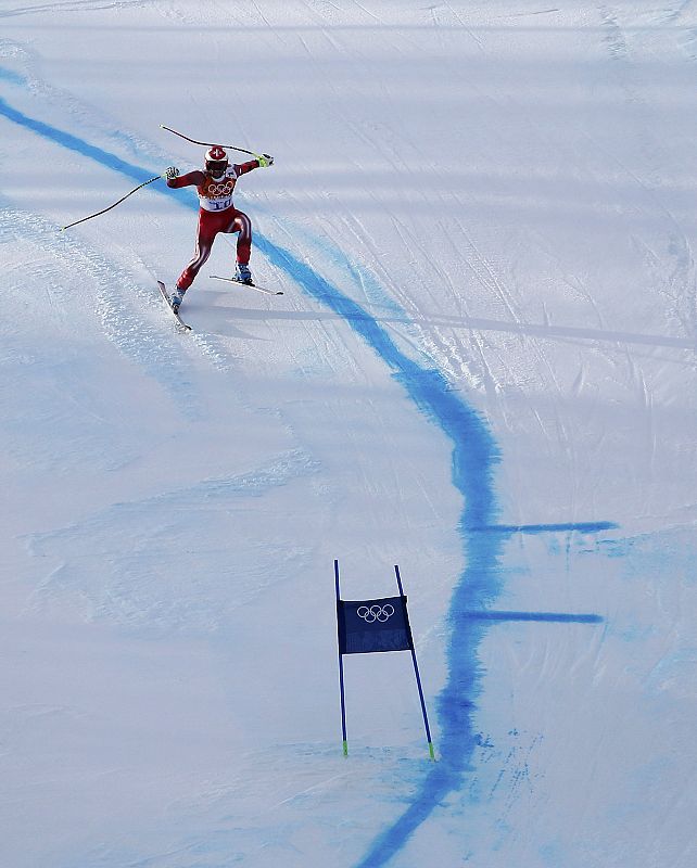 Switzerland's Didier Defago loses his balance in the men's alpine skiing Super-G competition during the 2014 Sochi Winter Olympics at the Rosa Khutor Alpine Center