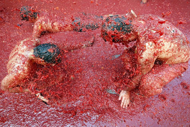 Las personas que han acudido a esta localidad valenciana se han lanzado 120.000 kilos de tomates y se han 'bañado' literalmente en los jugos de esta hortaliza.