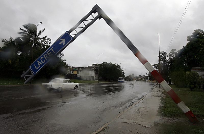 A traffic sign is seen leaning over a street after strong winds from Hurricane Ike blew across Havana