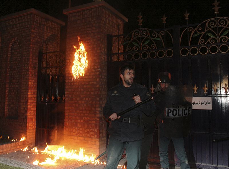 Iranian anti-riot policemen stand guard outside the British embassy in northern Tehran