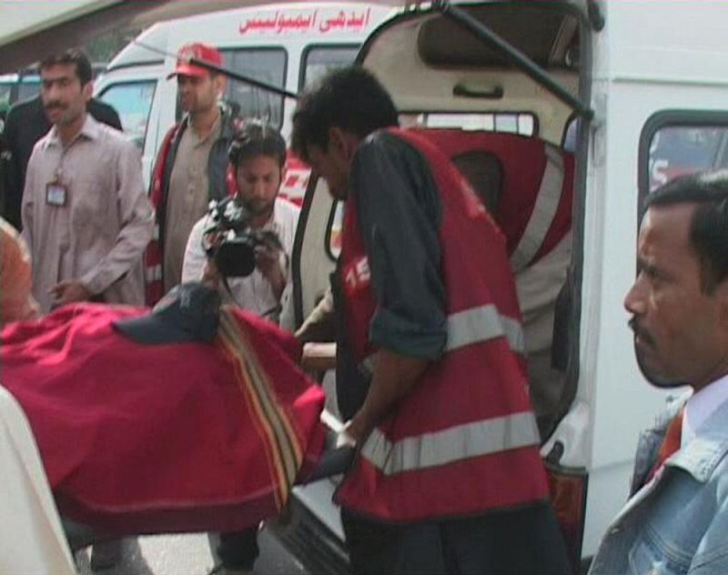 A video grab shows a body being put into an ambulance after an attack by gunmen in Lahore
