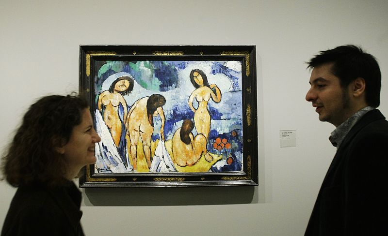 People talk next to painting during media presentation of exhibition "Maurice de Vlaminck, a Fauve Instinct" at Madrid's Caixa Forum