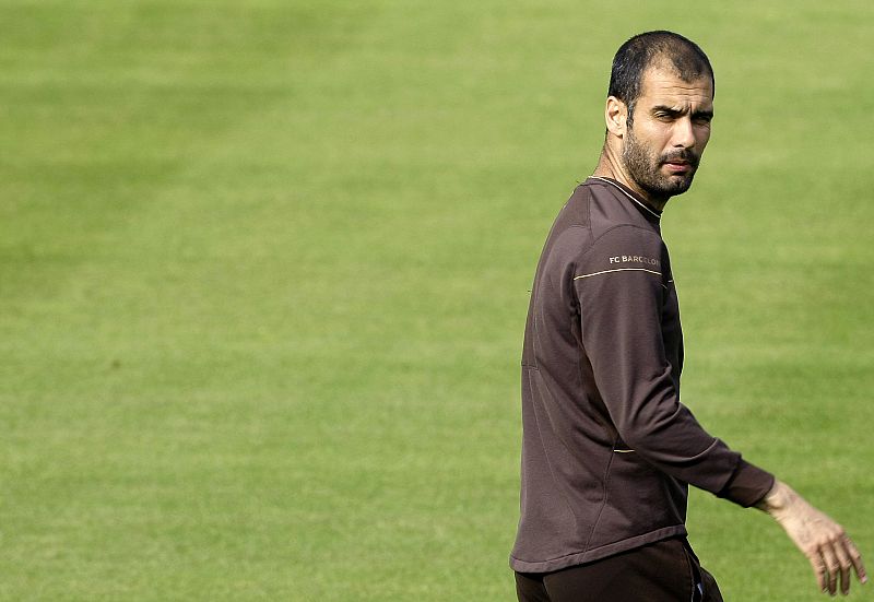 Barcelona's coach Josep Guardiola looks at journalists during a training session at "Ciutat esportiva Joan Gamper" in Sant Joan Despi near Barcelona