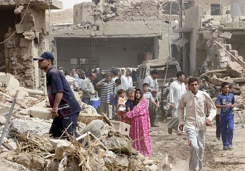 Residents gather at the site of a bomb attack in Kirkuk