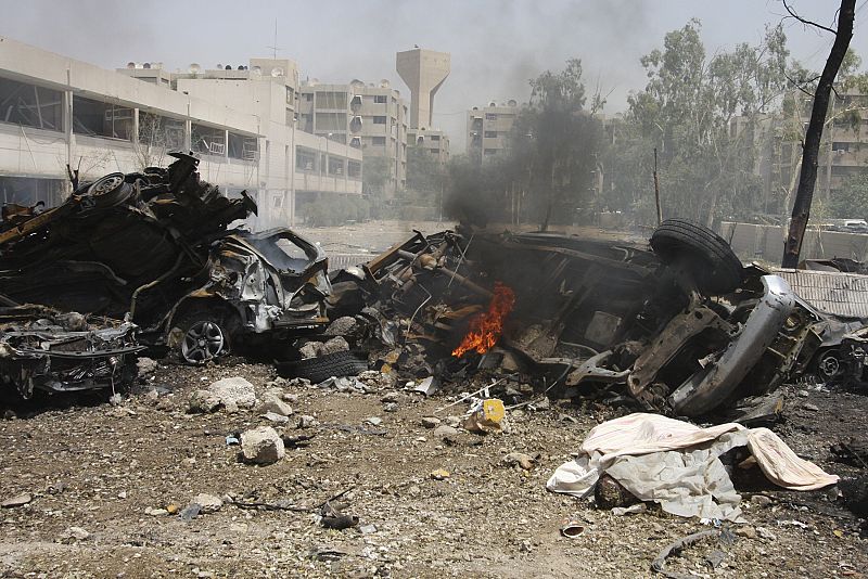 Burned and destroyed vehicles are seen at the site of a bomb attack in Baghdad
