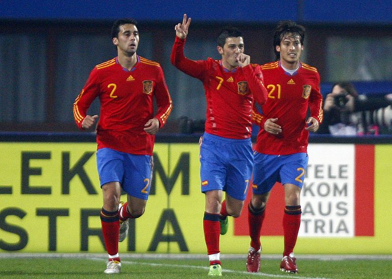 Spain's Villa celebrates with his team mates Arbeloa and Silva after scoring Spain's second goal during their international friendly soccer match in Vienna