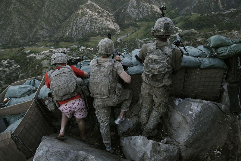 David Guttenfelder, a The Associated Press photographer based in the U.S., won the second prize in the People in the News Singles category for this picture of U.S. soldiers responding to Taliban fire outside their bunker, in Korengal Valley, Afghanis
