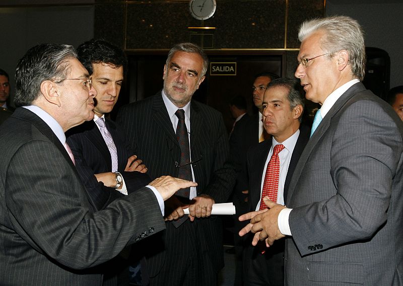 Colombia's Interior Minister Cossio speaks to International Criminal Court Chief Prosecutor Moreno-Ocampo during  Moreno-Ocampo's visit in Bogota