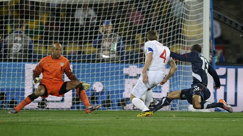 England's Gerrard shoots to score past Clark of the US and goalkeeper Howard during the 2010 World Cup Group C soccer match in Rustenburg