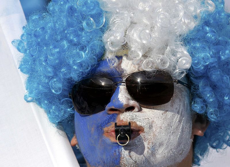 A soccer fan blows a whistle before start of World Cup quarter-final soccer match between Argentina and Germany at Green Point stadium in Cape Town
