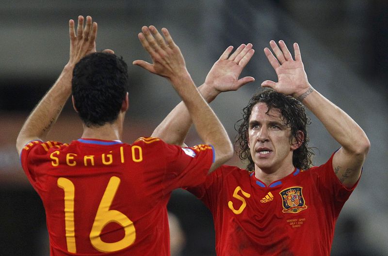 Spain's Puyol celebrates with Busquets during their 2010 World Cup semi-final soccer match against Germany in Durban