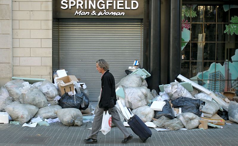 Basura amontonada ante una tienda cerrada de las Ramblas de Barcelona durante la jornada de huelga general.