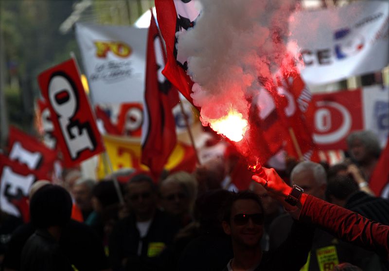 A demonstrator uses a flare in Nice