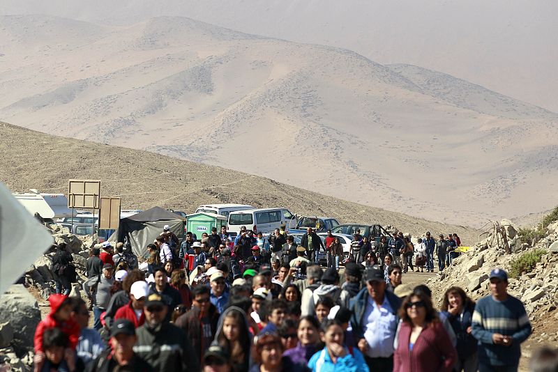 People arrive at the San Jose mine to attend a mass with the rescued miners which were trapped underground for 69 days, in Copiapo