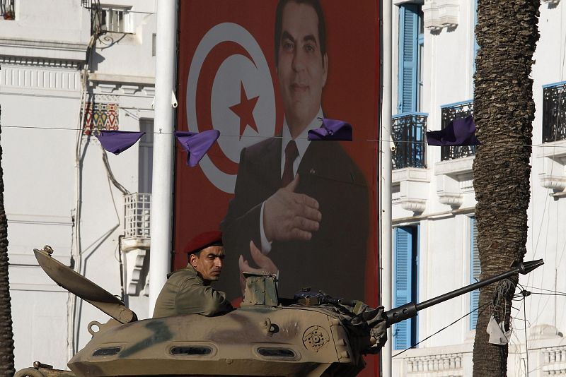 A Tunisian army soldier patrols in a tank in downtown Tunis