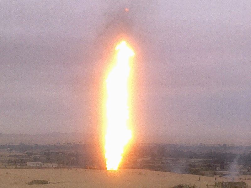 Flames are seen at the site of a pipeline blast in North Sinai