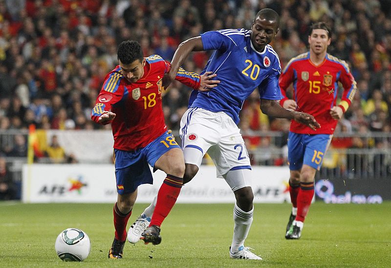 Spain's Pedro fights for the ball with Colombia's Zapata during their international friendly soccer match at Santiago Bernabeu stadium in Madrid