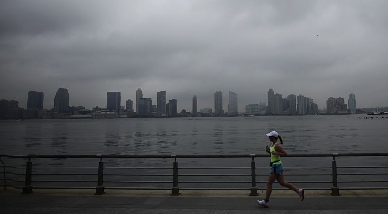 A woman jogs before the arrival of Hurricane Irene at downtown Manhattan in New York