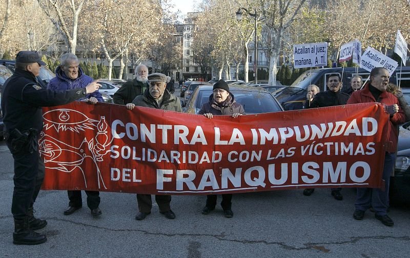 Un grupo de simpatizantes sostiene una pancarta en la que se puede leer "Contra la impunidad,solidaridad con las víctimas del franquismo", al tiempo que coreaban gritos en solidaridad con apoyo al juez e insistiendo en que "hay que juzgar al franquis