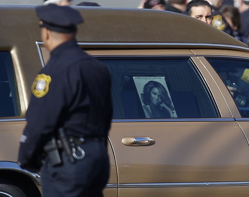 Newark Police officer watches as Houston's hearse arrives at New Hope Baptist Church in Newark
