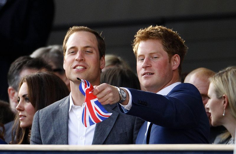 Britain's Prince Harry waves a Union Flag as he watches with Prince William and Catherine, Duchess of Cambridge during the Diamond Jubilee concert in front of Buckingham Palace in London