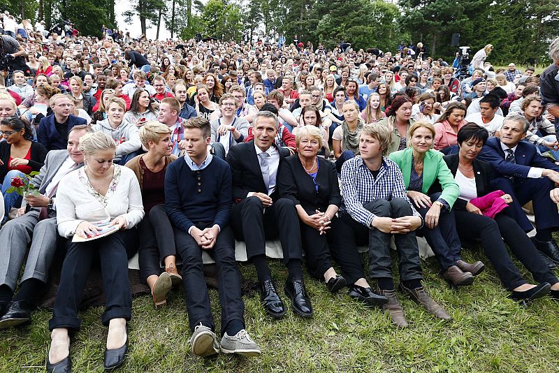 Members of AUF sit with guests and relatives of those who died a year ago, at the Utoeya island