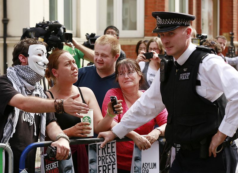 Protesters try to negotiate with police as they wait for Wikileaks founder Julian Assange  to speak to the media outside the Ecuador embassy in west London