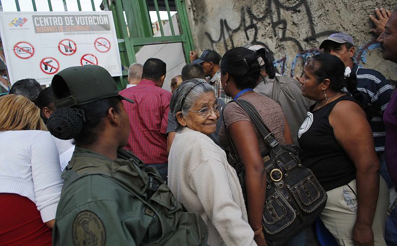 Venezuelans line up to vote for a successor to late President Hugo Chavez, in Caracas