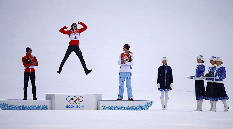 Winner Germany's Frenzel jumps on the podium during the flower ceremony for the Nordic Combined individual normal hill 10 km event at the Sochi 2014 Winter Olympic Games