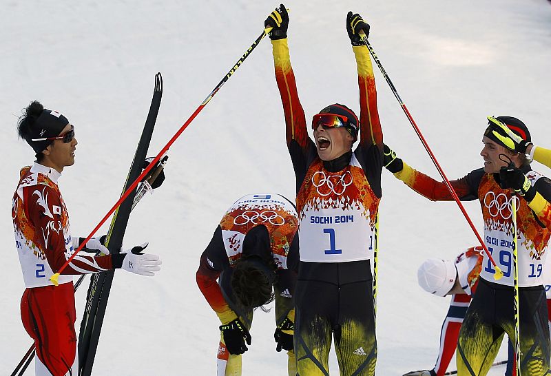 Germany's Frenzel celebrates next to Watabe and Riessle, after crossing the finish line in the cross country race of the Nordic Combined individual normal hill 10 km event of the Sochi 2014 Winter Olympic Games